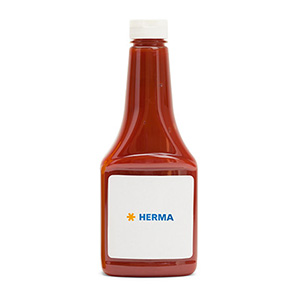 Flacon avec un liquide rouge, étiqueté "HERMA" sur une étiquette blanche.