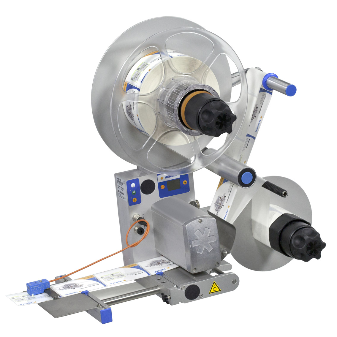 Machine à étiqueter avec deux rouleaux, un moteur et des commandes, utilisée pour appliquer des étiquettes sur des produits.
