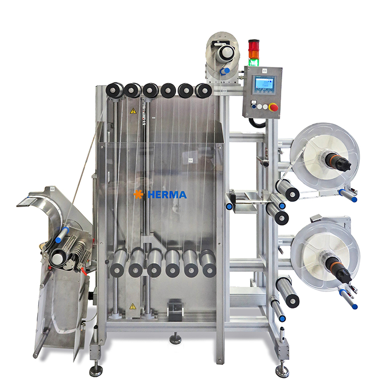 Machine étiqueteuse automatique avec plusieurs rouleaux, unité de contrôle et cadre en acier inoxydable. Idéale pour les applications industrielles.