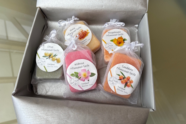 Étiquettes pour savons Etsy : une carte grise contient 5 étiquettes naturelles emballées dans des sachets en soie. Les étiquettes pour savons arborent le logo du vendeur Etsy et comportent une description du contenu.