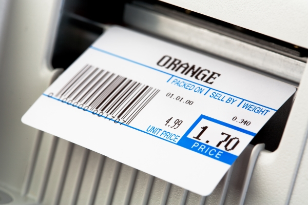 Étiquetage des aliments : Étiquette thermique imprimée pour les oranges, sur une balance.