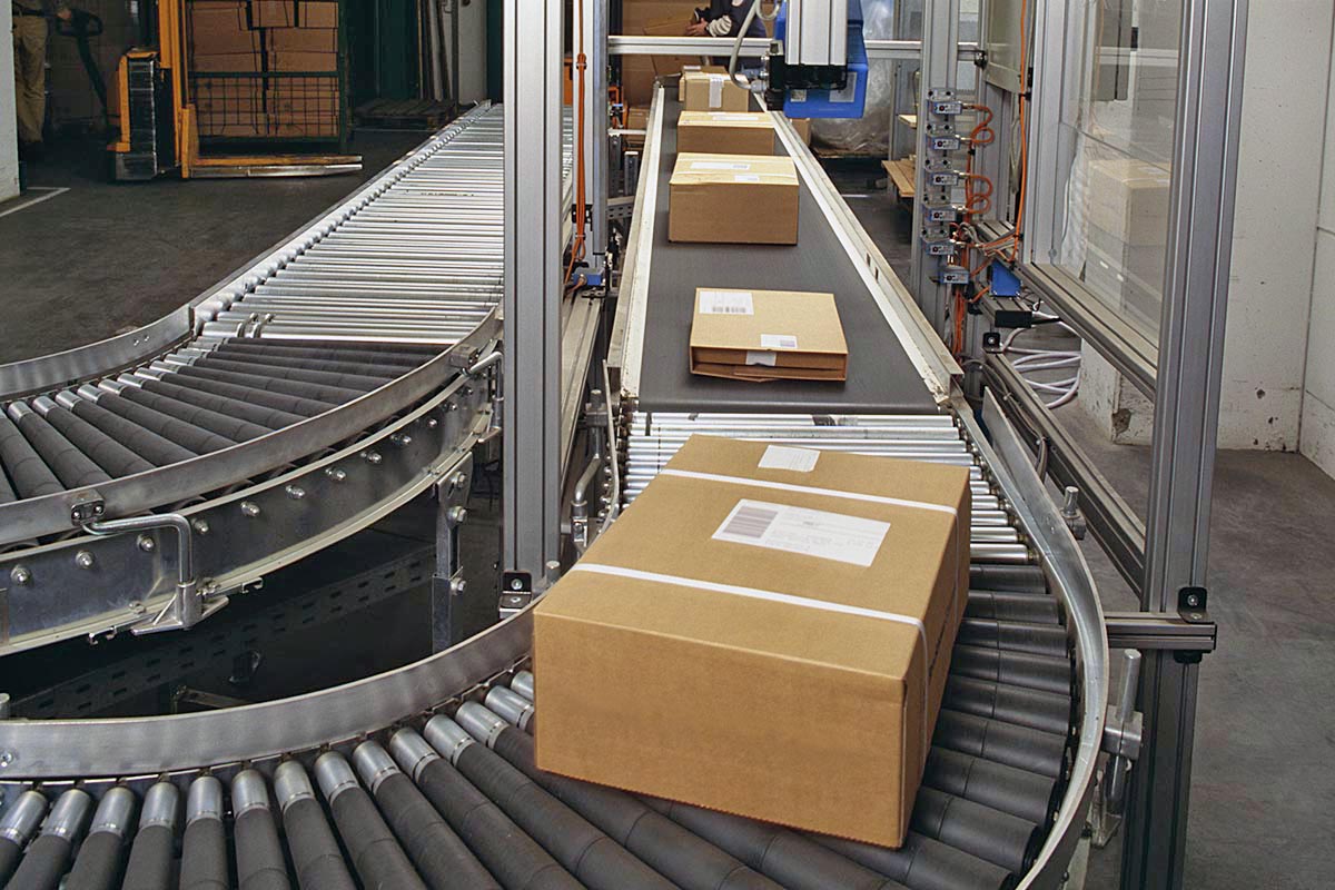 Étiquettes d'expédition et d palettes : étiquettes d'expédition sur des cartons filmés, sur un tapis roulant dans la logistique.