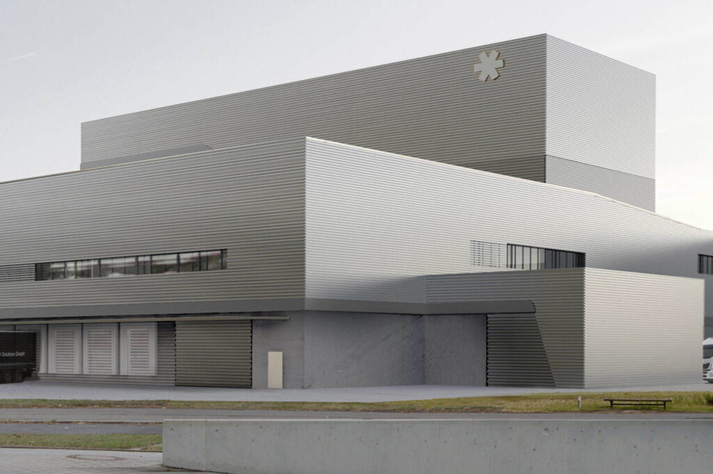 The translation of "Gebäude Werk 2" into French is "Bâtiment Atelier 2.