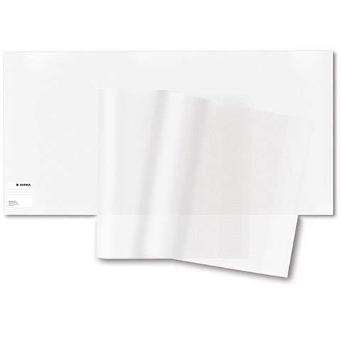 Transparente Folienblätter liegen auf einem weißen Untergrund. Die Folien sind teilweise übereinandergelegt und zeigen eine glatte Oberfläche.