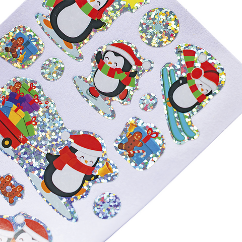 Bunte Aufkleber mit Pinguinen, Geschenken und Lebkuchenmännern, verziert mit Glitzer und winterlichen Motiven.
