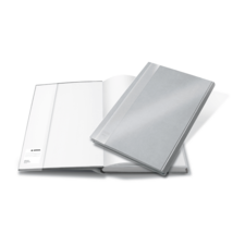 Ein offenes Notizbuch mit leeren Seiten und einem geschlossenen, silbernen Einband daneben.