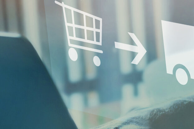 Processus d'achat avec des symboles pour le panier, la livraison et l'utilisateur, représentés au-dessus d'un ordinateur portable.