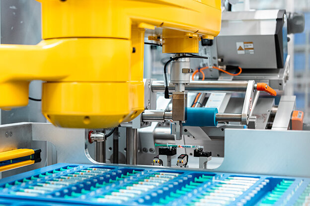 Des robots industriels avec deux modèles différents, l'un sur une table et l'autre sur une unité de montage, entourés de graphiques techniques.