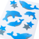Autocollants pailletés bleus en forme de dauphins et d'étoiles sur fond blanc.